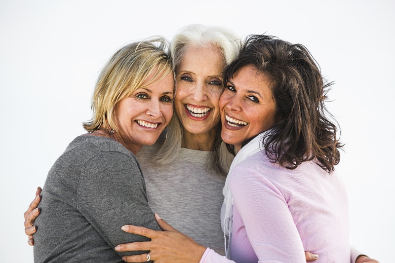 Three elderly woman hugging